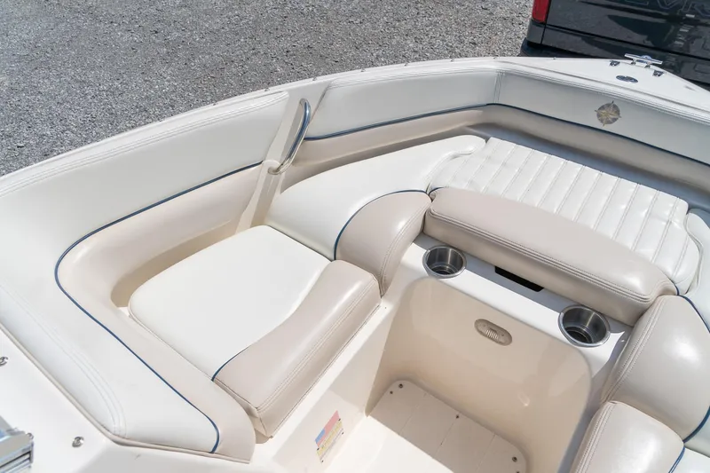 Slide: The Image of 2007 Bryant 190 boat interior with white leather seating and cup holders. - 16