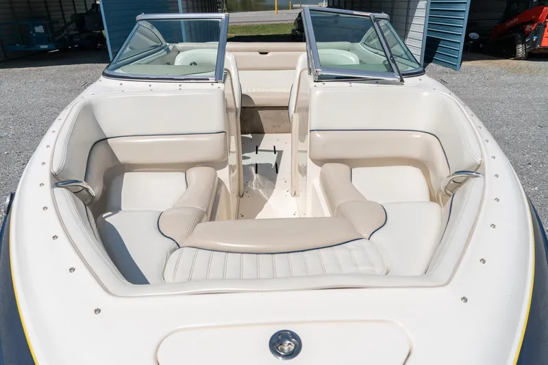 Slide: The Image of 2007 Bryant 190 boat interior with beige seating and open windshield. - 19