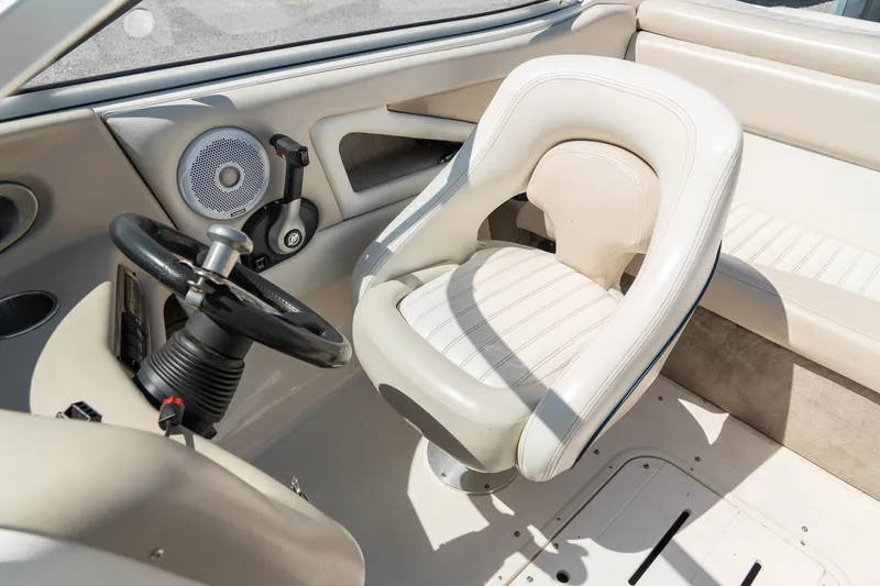 Slide: The Image of Interior of a 2007 Bryant 190 boat featuring steering wheel and white seating. - 21