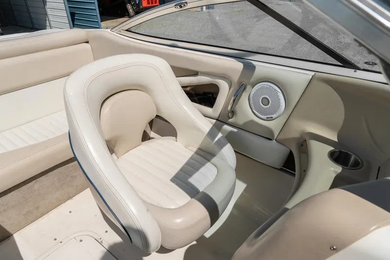Slide: The Image of Interior of a 2007 Bryant 190 boat featuring beige seating and speaker system. - 22