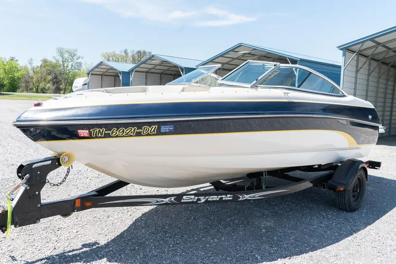 Slide: The Image of 2007 Bryant 190 boat on trailer, parked outdoors near storage units. - 3