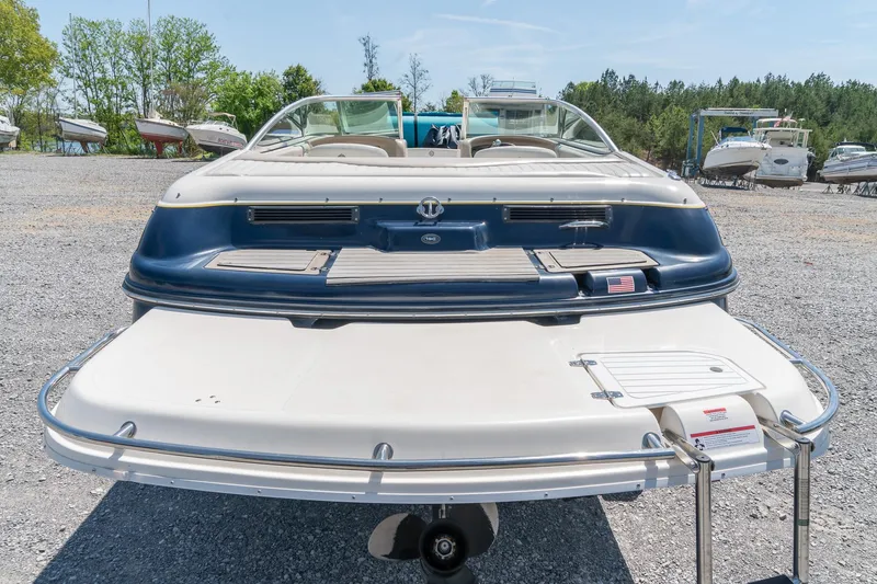 Slide: The Image of Rear view of a 2007 Bryant 190 boat in a gravel lot with other boats. - 9