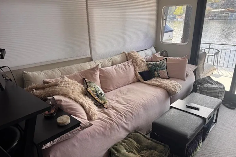 Slide: The Image of Cozy interior of 1985 Three Buoys houseboat with plush seating and waterfront view. - 10