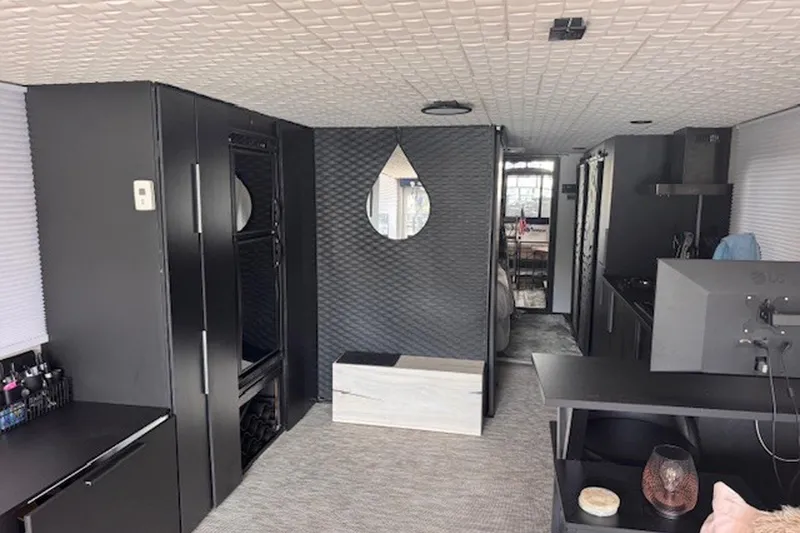 Slide: The Image of Modern interior of a 1985 Three Buoys houseboat with sleek black furnishings and contemporary decor. - 13