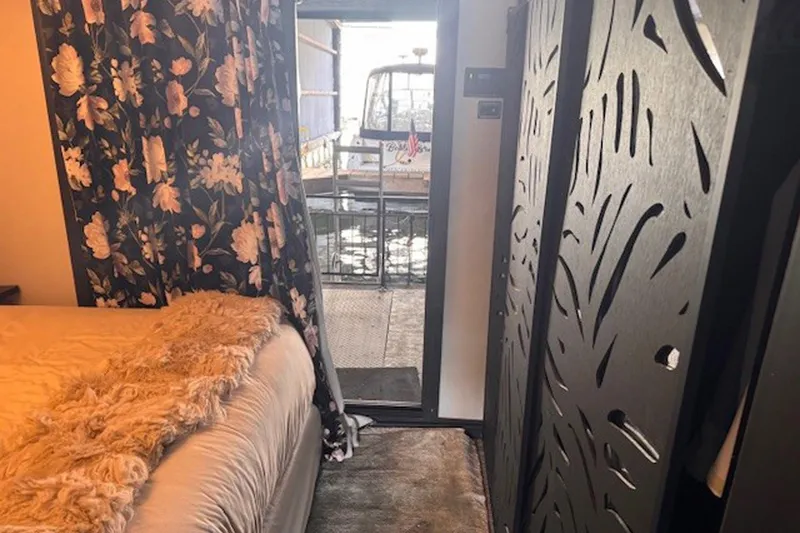 Slide: The Image of Cozy 1985 Three Buoys houseboat interior with floral curtains and decorative paneling. - 18