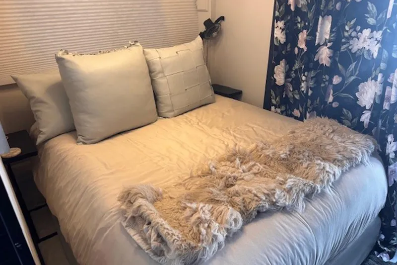 Slide: The Image of Cozy bedroom in 1985 Three Buoys houseboat with floral curtains and plush bedding. - 20