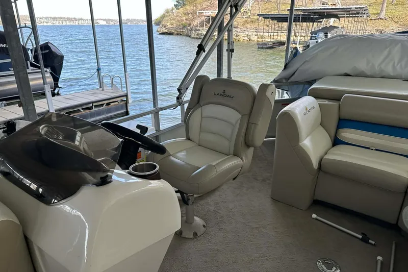Slide: The Image of Interior of a 2008 Landau Atlantis 250 Sport Cruise boat docked by a scenic lake. - 11