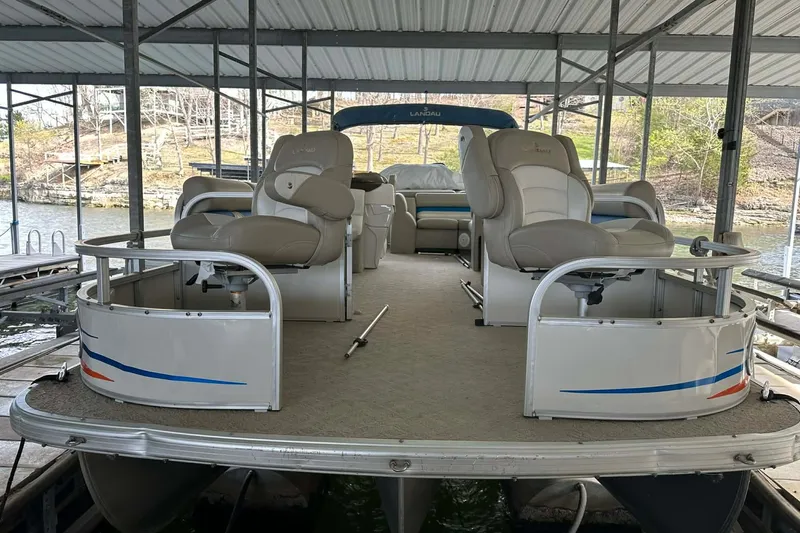 Slide: The Image of 2008 Landau Atlantis 250 Sport Cruise pontoon boat docked under a covered marina. - 12