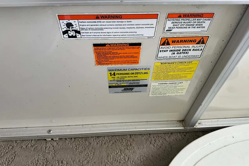Slide: The Image of Warning labels and capacity information on a 2008 Landau Atlantis 250 Sport Cruise boat. - 14