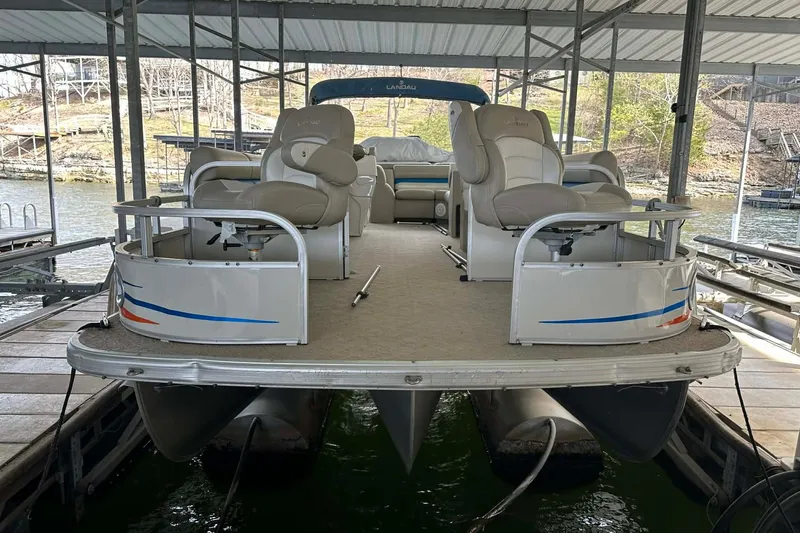 Slide: The Image of 2008 Landau Atlantis 250 Sport Cruise pontoon boat docked under a covered marina. - 15