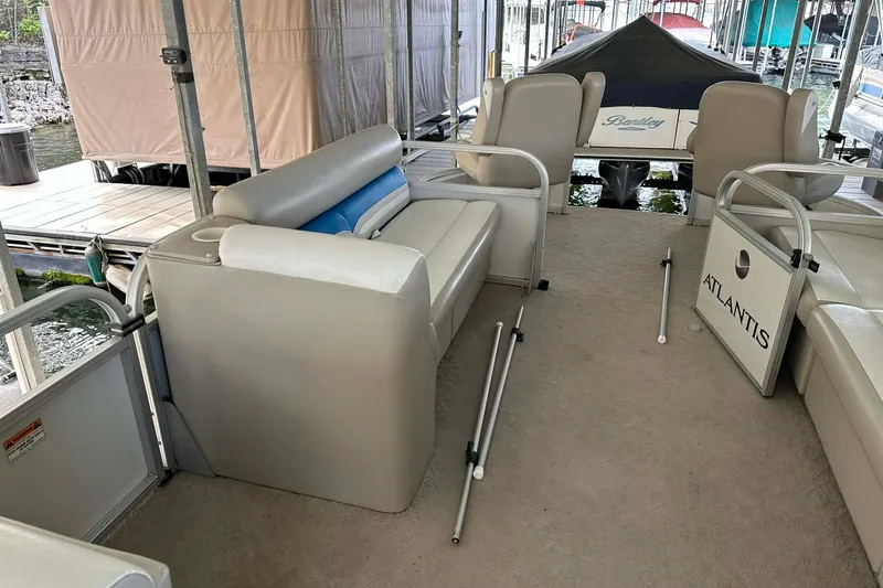 Slide: The Image of 2008 Landau Atlantis 250 Sport Cruise interior with beige seating and open deck layout. - 16