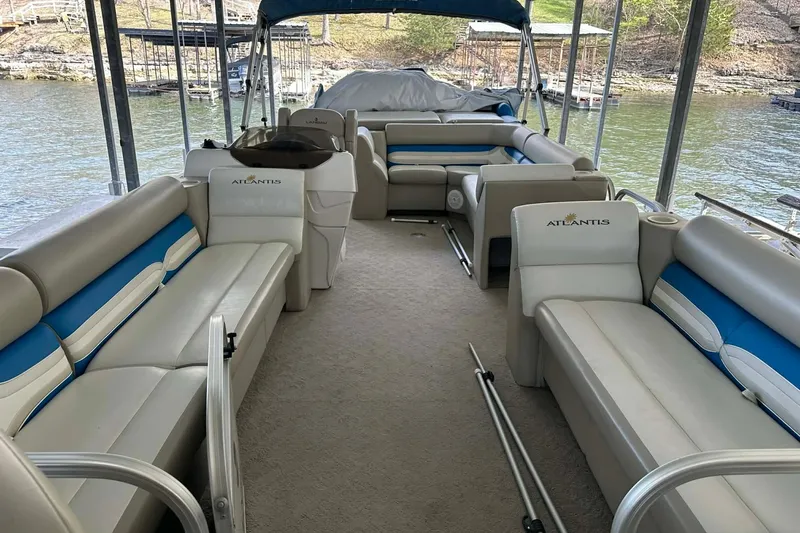 Slide: The Image of 2008 Landau Atlantis 250 Sport Cruise pontoon boat interior with blue and white seating. - 17
