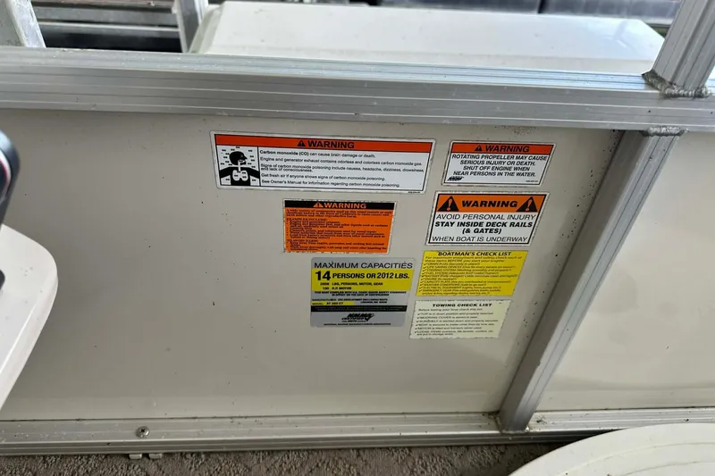 Slide: The Image of Warning labels on a 2008 Landau Atlantis 250 Sport Cruise boat, detailing safety and capacity. - 21