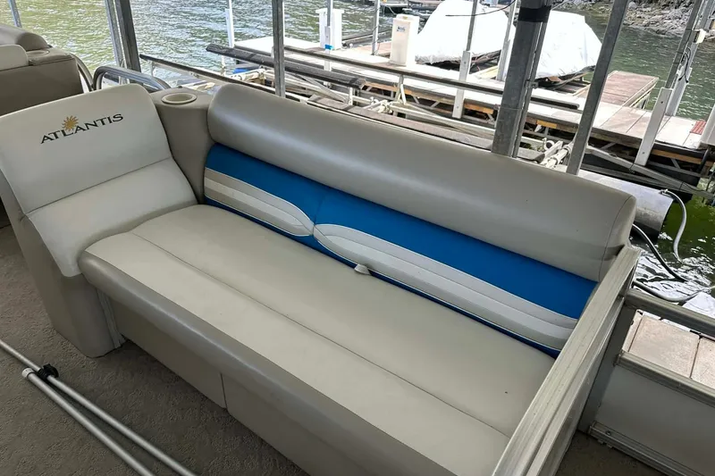 Slide: The Image of 2008 Landau Atlantis 250 Sport Cruise boat interior with beige and blue seating. - 4