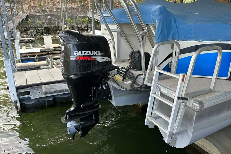 Slide: The Image of 2008 Landau Atlantis 250 Sport Cruise with Suzuki outboard motor at dock. - 5