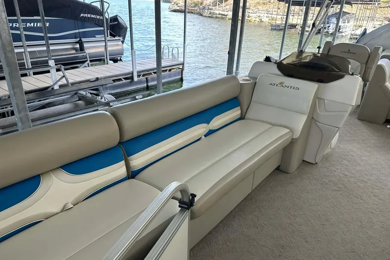 Slide: The Image of 2008 Landau Atlantis 250 Sport Cruise boat interior with beige and blue seating. - 6