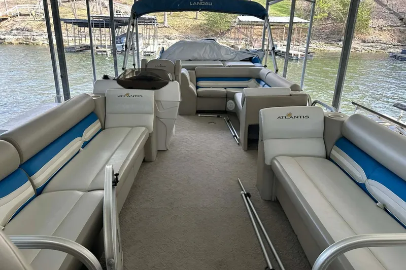 Slide: The Image of 2008 Landau Atlantis 250 Sport Cruise pontoon boat interior with spacious seating and lake view. - 8