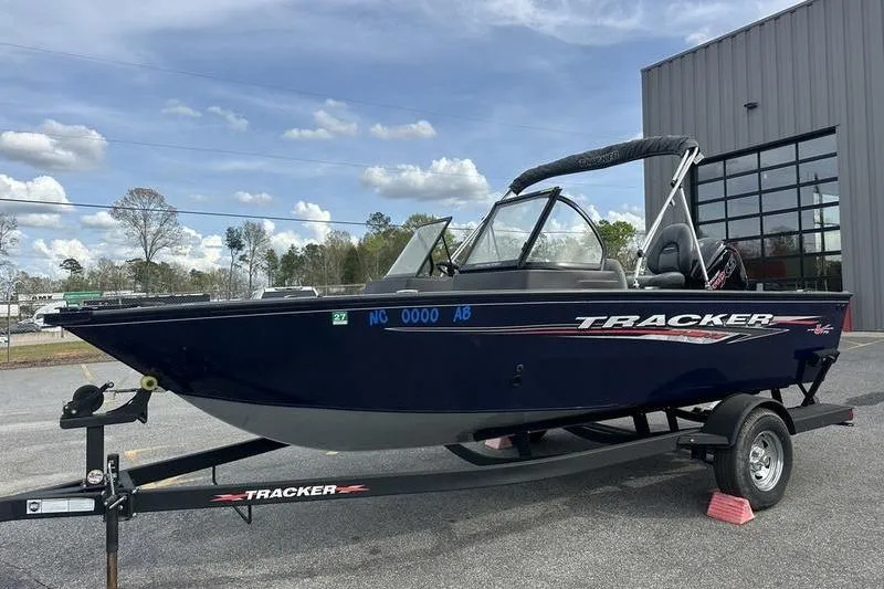 The Image of 2024 Tracker Pro Guide V-175 WT boat on trailer, parked outdoors near a building. - 0
