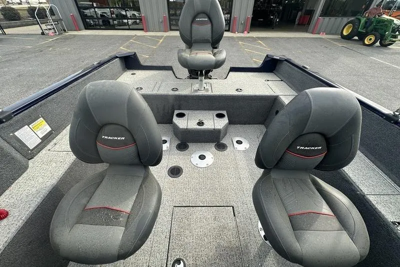 Slide: The Image of 2024 Tracker Pro Guide V-175 WT boat interior with three cushioned seats. - 5