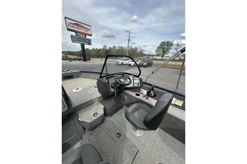 Slide: The Image of 2024 Tracker Pro Guide V-175 WT boat interior with steering wheel and seating. - 6