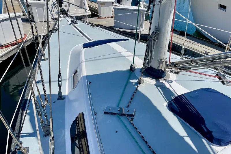 Slide: The Image of 1979 Catalina 38 sailboat deck with rigging and mast at marina. - 13