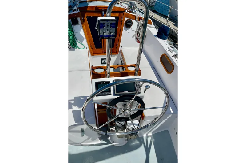 Slide: The Image of Cockpit of a 1979 Catalina 38 sailboat with steering wheel and navigation instruments. - 19