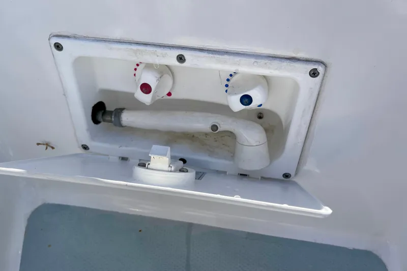 Slide: The Image of Boat shower controls on a 1979 Catalina 38, featuring hot and cold water knobs. - 23
