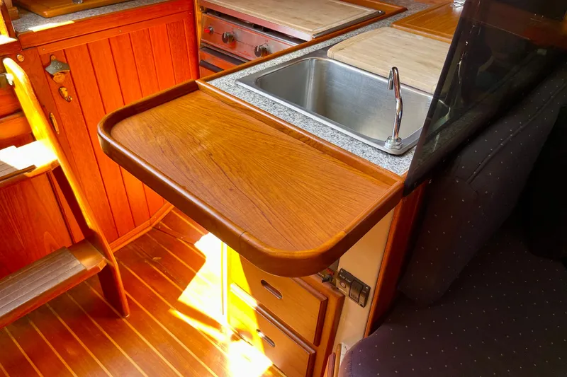 Slide: The Image of 1979 Catalina 38 yacht interior with wooden cabinetry and stainless steel sink. - 34