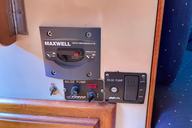 Slide: The Image of Control panel of a 1979 Catalina 38 sailboat featuring Maxwell circuit breaker and bilge pump switches. - 35