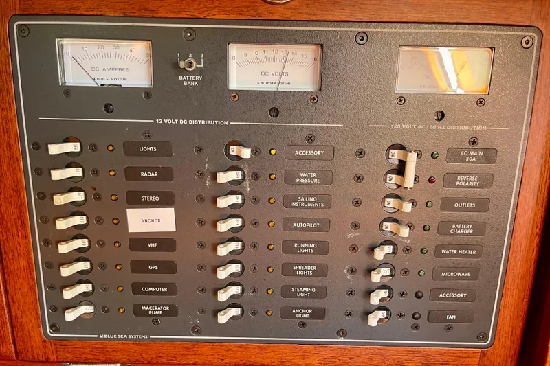 Slide: The Image of Electrical control panel on a 1979 Catalina 38 sailboat, featuring various switches and gauges. - 39