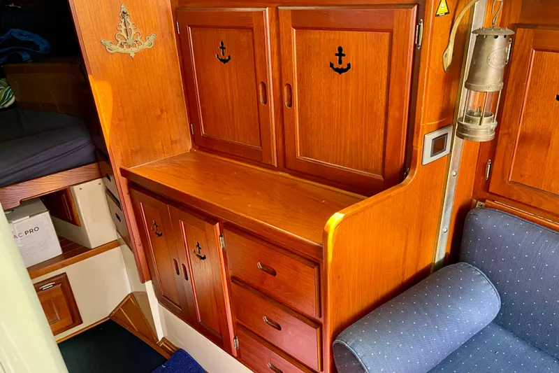 Slide: The Image of Interior of 1979 Catalina 38 sailboat with wooden cabinets and nautical decor. - 42