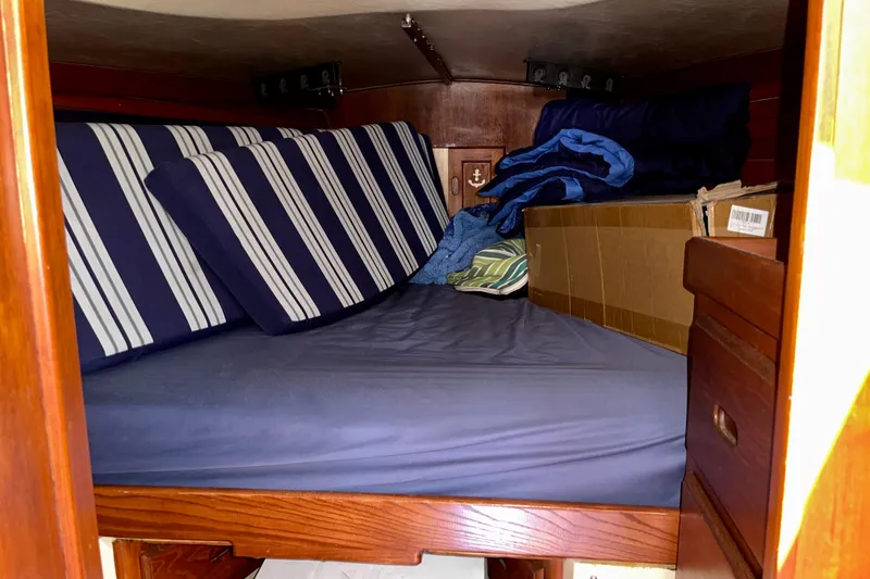 Slide: The Image of Cozy cabin interior of a 1979 Catalina 38 sailboat with striped cushions. - 43