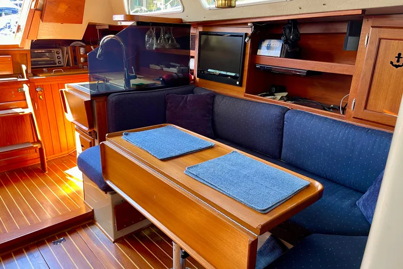 Slide: The Image of Interior of a 1979 Catalina 38 sailboat with cozy seating and wooden finishes. - 49
