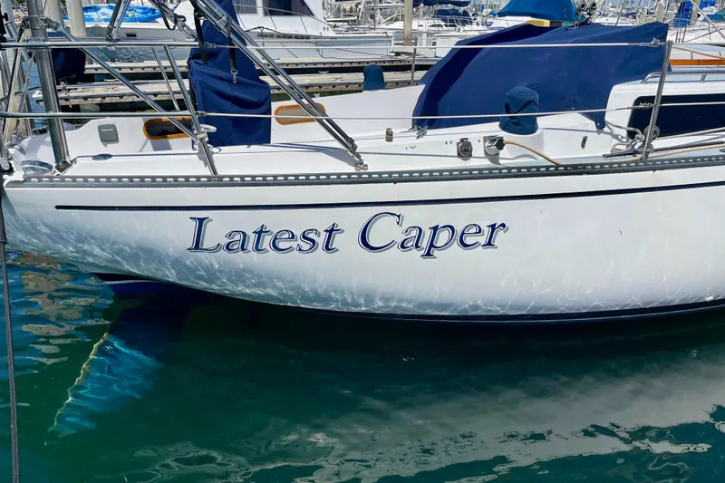 Slide: The Image of 1979 Catalina 38 sailboat named "Latest Caper" docked in marina. - 7