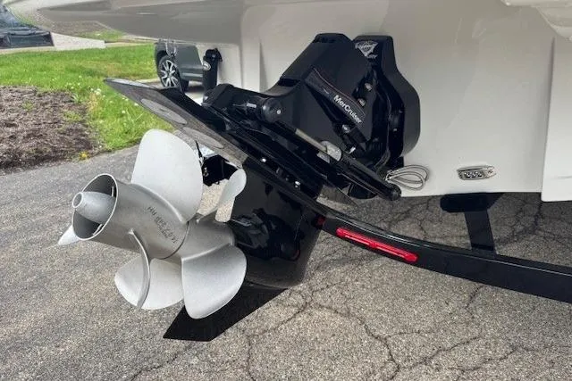 Slide: The Image of 2025 Crownline 280 SS boat propeller and outdrive on pavement. - 11