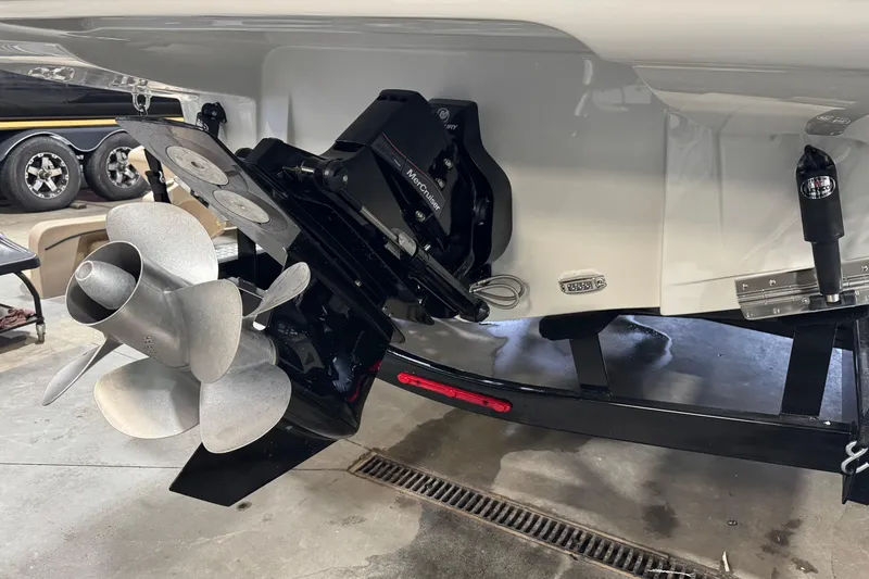 Slide: The Image of 2025 Crownline 280 SS boat propeller and stern drive in a garage setting. - 12