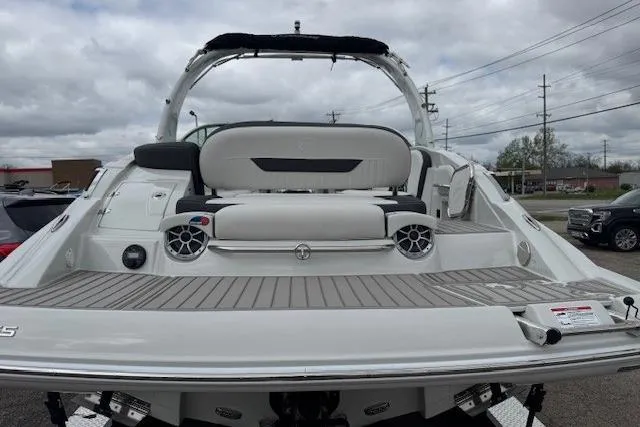 Slide: The Image of 2025 Crownline 280 SS boat with sleek design and spacious seating on a cloudy day. - 15