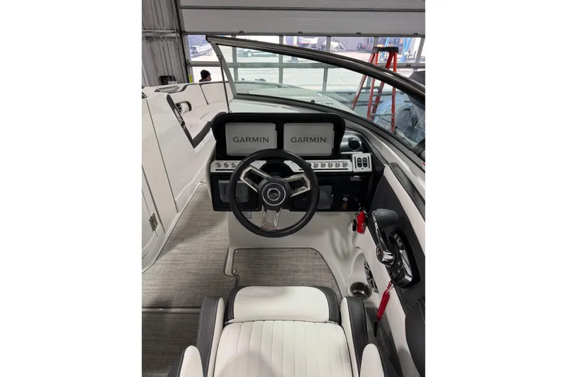 Slide: The Image of 2025 Crownline 280 SS boat cockpit with Garmin navigation system and modern steering wheel. - 21