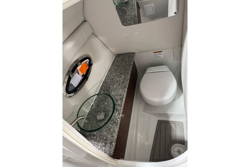 Slide: The Image of Luxurious bathroom in 2025 Crownline 280 SS boat with modern fixtures and granite countertop. - 25