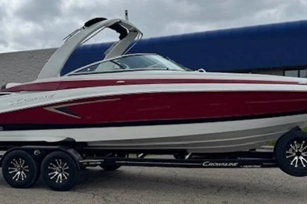 The Image of 2025 Crownline 280 SS boat on trailer, red and white design, parked outdoors. - 8