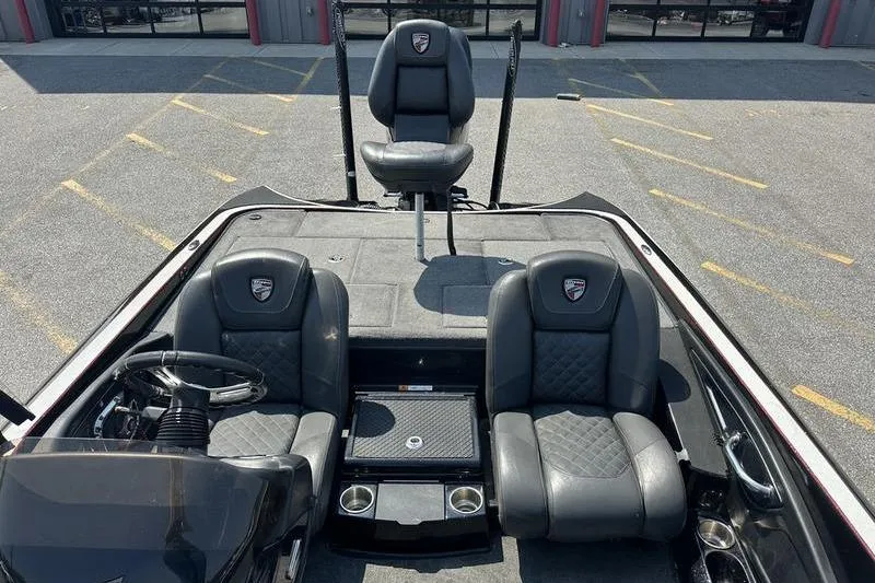 Slide: The Image of 2016 Triton 20 TrX boat interior with three black seats and steering wheel. - 10