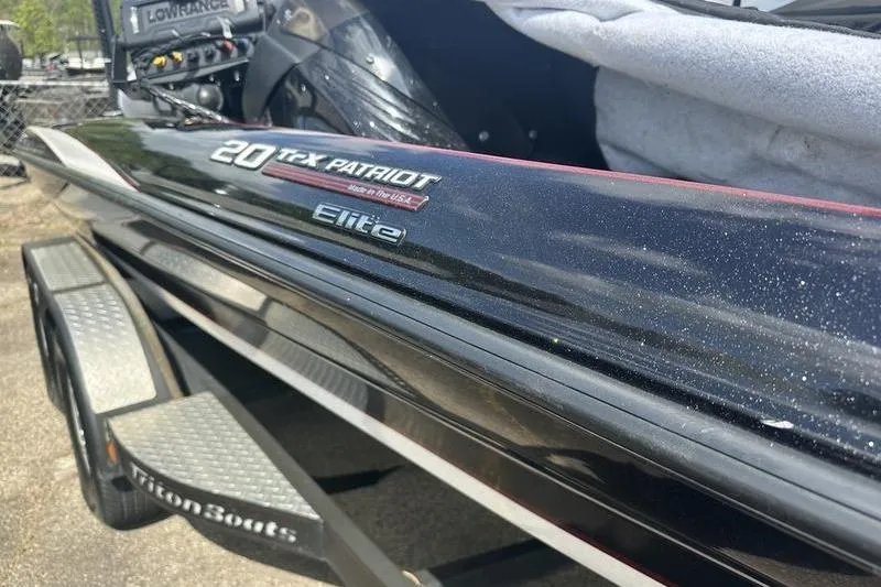 Slide: The Image of 2016 Triton 20 TrX Patriot Elite boat on trailer, close-up view. - 11