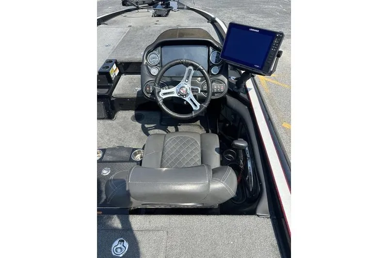 Slide: The Image of 2016 Triton 20 TrX boat cockpit with steering wheel and navigation display. - 3