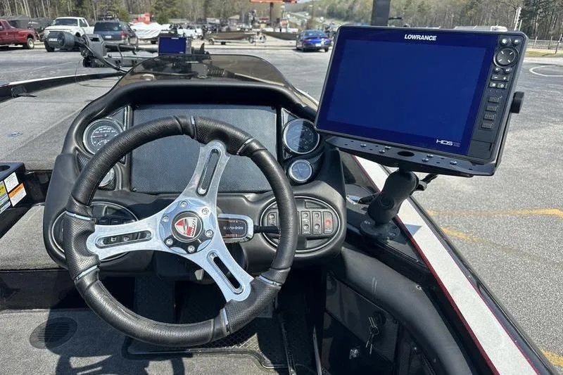 Slide: The Image of 2016 Triton 20 TrX boat dashboard with steering wheel and Lowrance HDS display. - 4