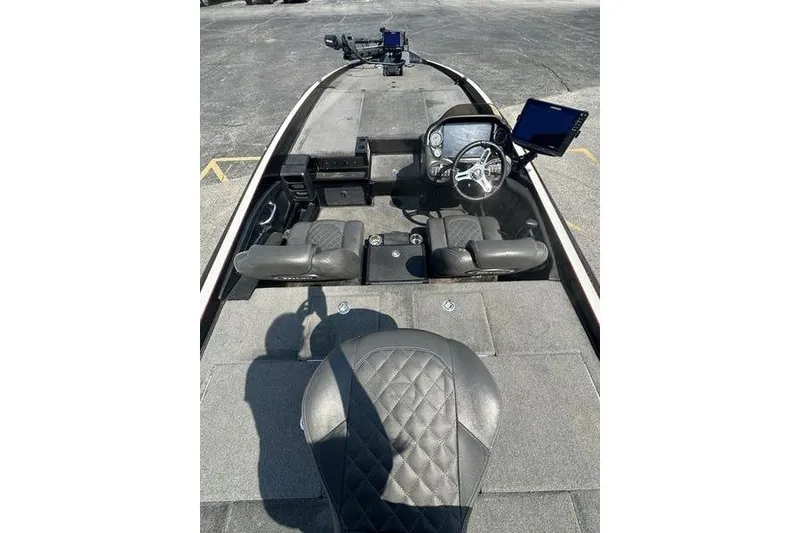 Slide: The Image of 2016 Triton 20 TrX boat interior with steering wheel and seating. - 5