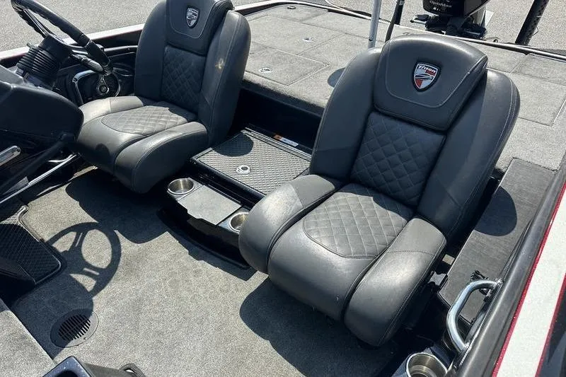 Slide: The Image of 2016 Triton 20 TrX boat interior with two black leather seats. - 6