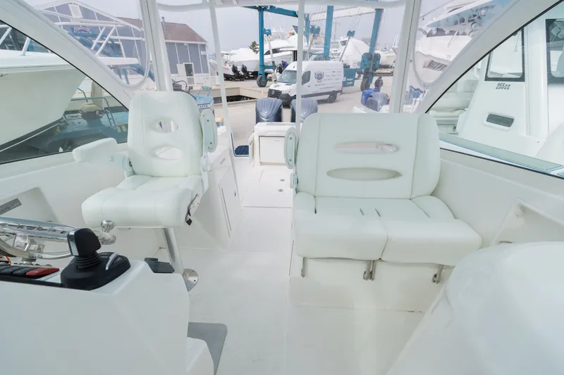 Slide: The Image of Interior of a 2022 Albemarle 27 DC boat with white seating. - 11