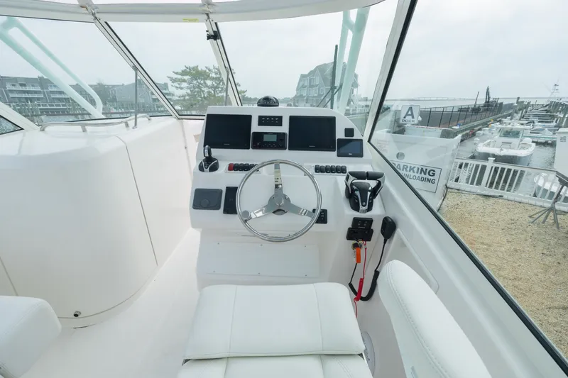 Slide: The Image of Interior view of 2022 Albemarle 27 DC boat with modern helm console. - 8