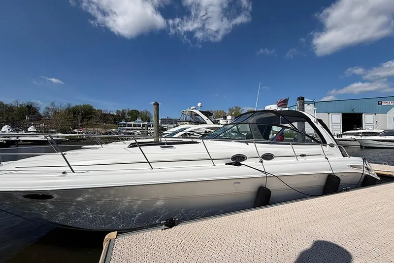 Slide: The Image of 2001 Sea Ray 410 Express Cruiser docked at marina under blue sky. - 1
