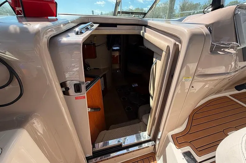 Slide: The Image of 2001 Sea Ray 410 Express Cruiser cabin entrance with teak flooring and open door. - 12